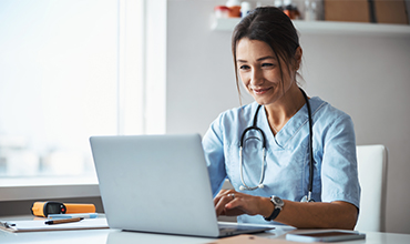 Doctor at laptop computer