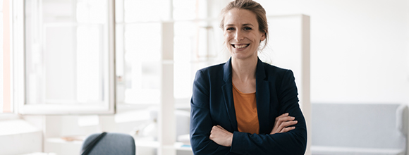 Smiling business woman with arms folded