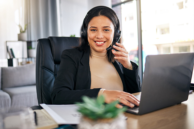 A women helping out a customer on the phone.