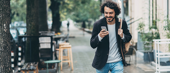 Man walking looking at mobile