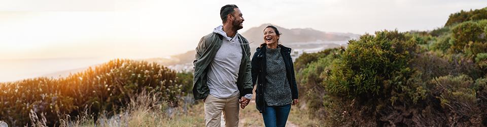 Couple holding hands on sunset stroll