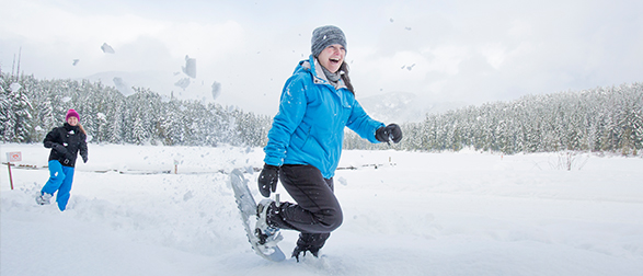 Woman snow showing having a great time.