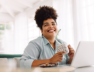 Happy woman in front of laptop computer