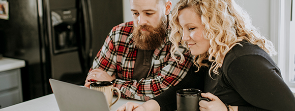 Man and woman looking at tablet in kitchen