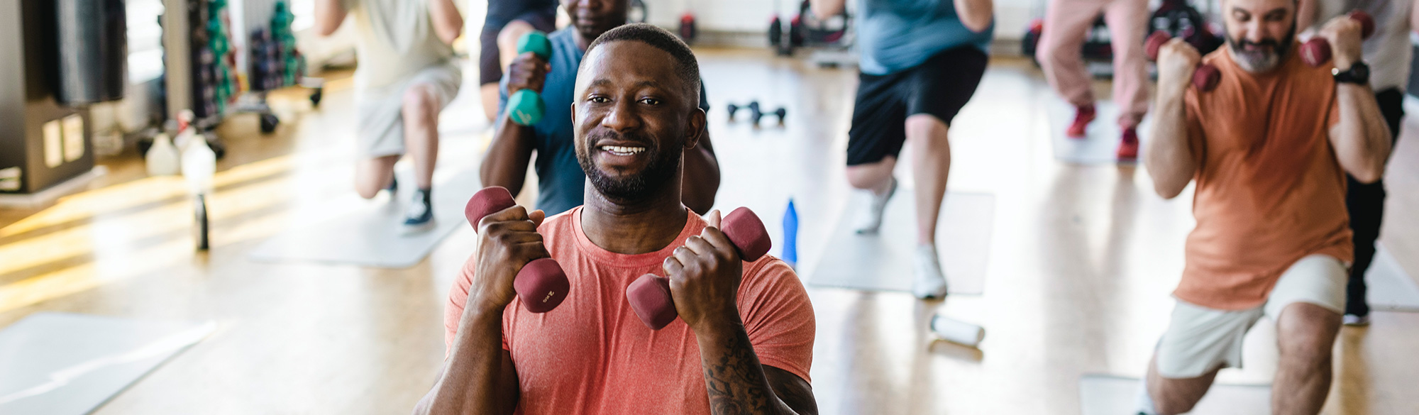 Working out in a class lifting hand weights 